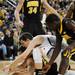 Michigan freshman Nik Stauskas battles Iowa senior Eric May for a loose ball during the first half against Iowa at Crisler Center on Sunday, Jan. 6. Michigan beat Iowa 95-67 in the Big Ten home opener. Melanie Maxwell I AnnArbor.com